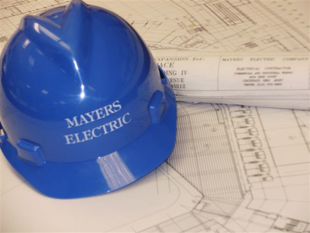 Mayers Electric hard hat on blueprints
